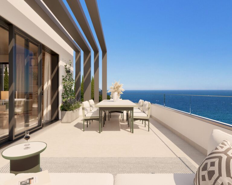 Covered terrace with dining table overlooking the Mediterranean
