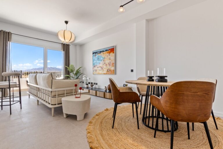 Show apartment living and dining area with mountain views