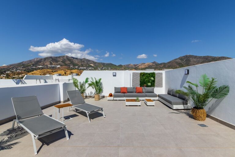 Show apartment roof terrace with sun loungers and mountain views